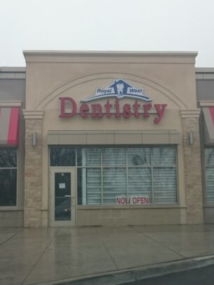 Royal West Dentistry storefront with 'Now Open' sign