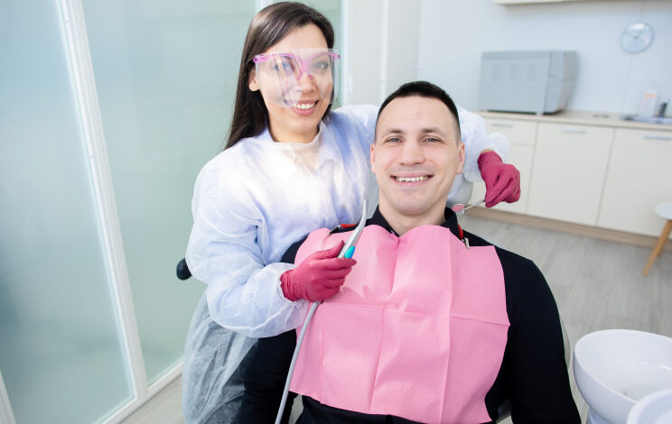 Happy Patient with Smiling Dentist in a Dental Clinic