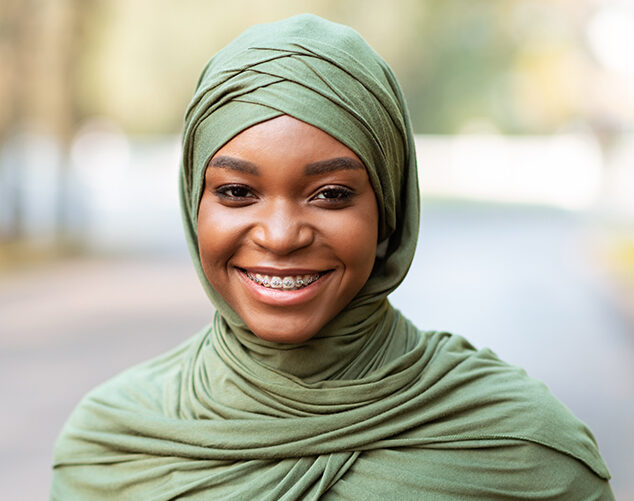 Lady showing braces on her teeth while smile